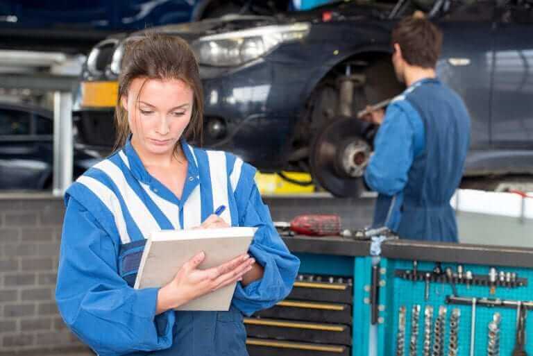 A mechanic looking over a checklist