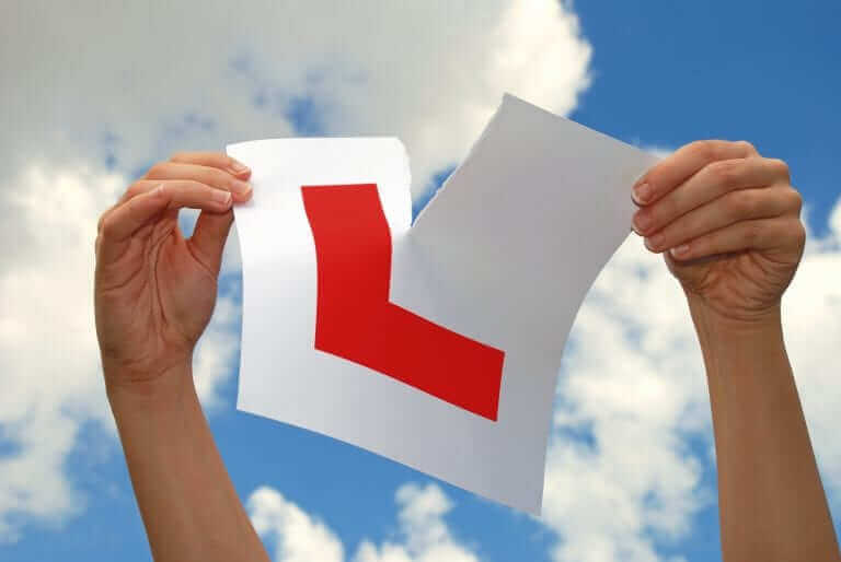 A learning tearing up the learner sign
