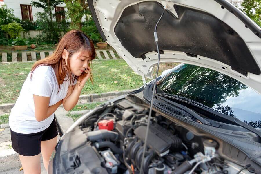 A woman looking her bonnet on the phone